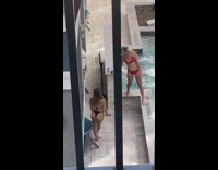 Woman red bikini wiggle butt mini waterfalls poolside