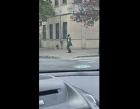 Security guard on street dancing slowly and seductively on beat