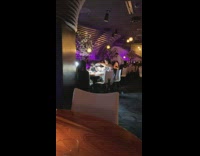 Women photograph food inside restaurant use lighting