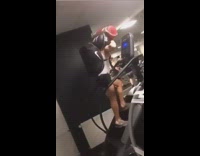 Guy climbs stairmaster while holding full bags