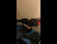 Man bench presses his friend on the bed 