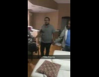 Dog standing on chair joins in holding hands in prayer circle