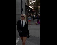 Woman in suit walks stranger tripped behind