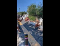 Collab IITW - Woman yellow dress tiktok video Santorini street