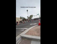 Bike racers pass by at street corner
