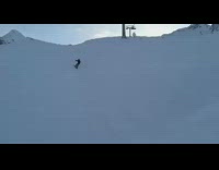 Snowboarder jumps off ramp, back flips and lands on head