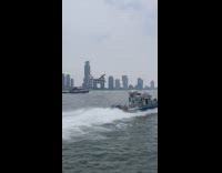 Amphibious plane and boat pass by on river