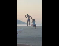 Man in briefs flexes muscle at the docks