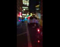 Cyclist ride beside DJ on bus playing music