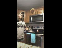 Girl flips pancake with eyes closed drops on floor