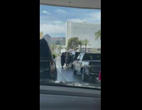 Man in a suit exits the car and talks to the camera