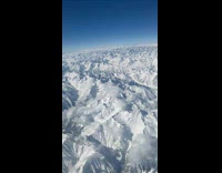 View of the snow covered Himalayas from the airplane