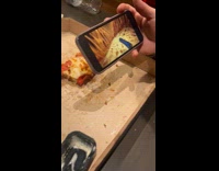 Guy films pizza while friend plays game 