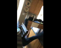 Girl balancing swinging between counter and chair falls backwards on floor