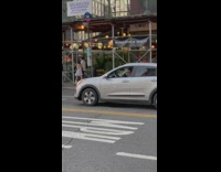 Guy head bangs while drumming on steering wheel