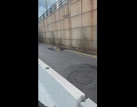 Bus stops by large pothole crack street