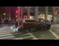 Black truck two brown pianos in trunk