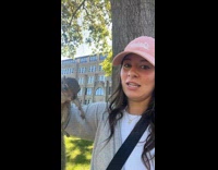 Woman on campus holding wild squirrel 