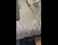 Guy at desk looks down at kitten 