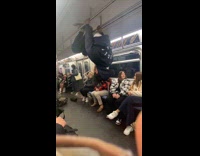 Collab NewYorkers - Man dances and hangs on train handrails