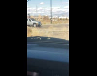 Guy girl in car tumbleweed flies around 