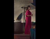 Woman pink jumpsuit hold glass  bar night