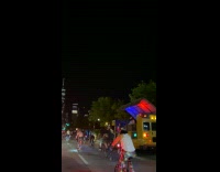 Cyclist follow DJ on bus playing music