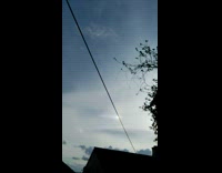 Partial rainbow halo seen in the blue sky