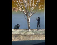 Woman poses with cake corner of building