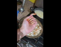 Woman puts shrimp heads on fingers pretending they are nails