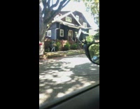 Girl brown bag green plants skips sidewalk 