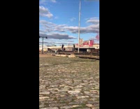 Man black jacket spin red smoke bomb