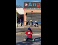 Disabled man rides skateboard at the marathon