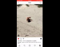 Girl runs down sand hill with giant inflatable swan floaty and face plants into the sand