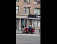 Man on red motorcycle playing music crosswalk