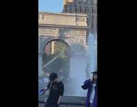 Man climbs on crane in park in front of girl taking graduation photos
