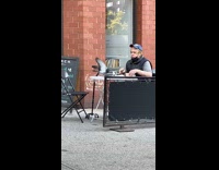 Old man try to shoo away pigeon