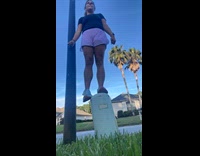 Woman poses on coax line pedestal and breaks it