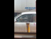 Man in mask roll blunt inside car