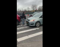 Two guys argue golf club blue car 