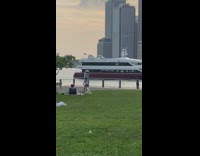 Man ride bike balance trash can on head