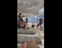 Woman blue bikini hold tree trunk pictorial