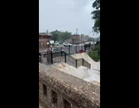 Flood water pours down on train station