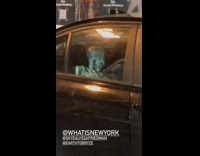 Fake skeleton decoration in parked black car 