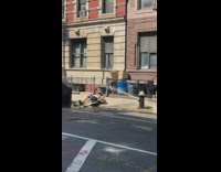 Guy lays on back sidewalk fire hydrant 