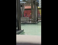 Woman pink bikini over the shoulder look flips hair