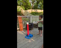 Boy swings bat hit ball towards camera