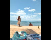 Woman in dress jump shot at beach