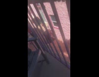 Woman in tank top raises hand in the alleyway