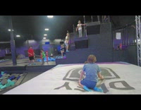 Boy jumps off platform lands on girl 